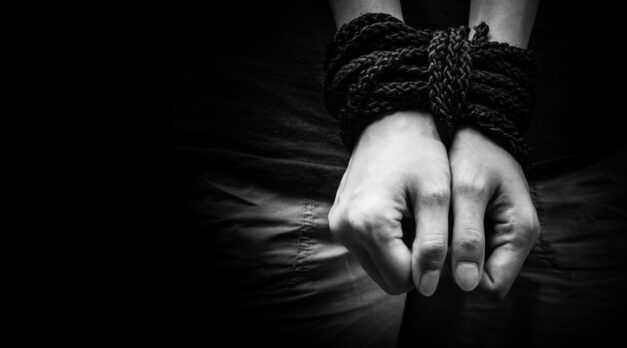 Hands of a missing kidnapped, abused, hostage, victim woman tied up with rope in emotional stress and pain, afraid, restricted, trapped, call for help, struggle, terrified, locked in a cage cell.
